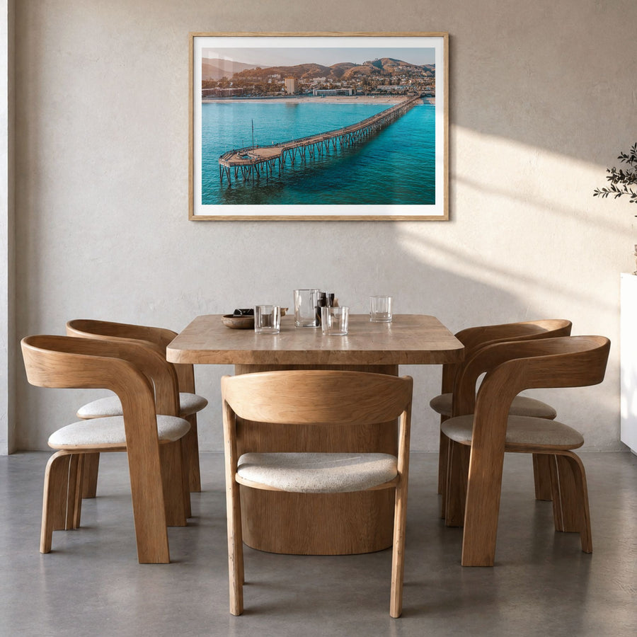 Ventura Photo Poster in a natural wood frame, hanging in a dining room, white border