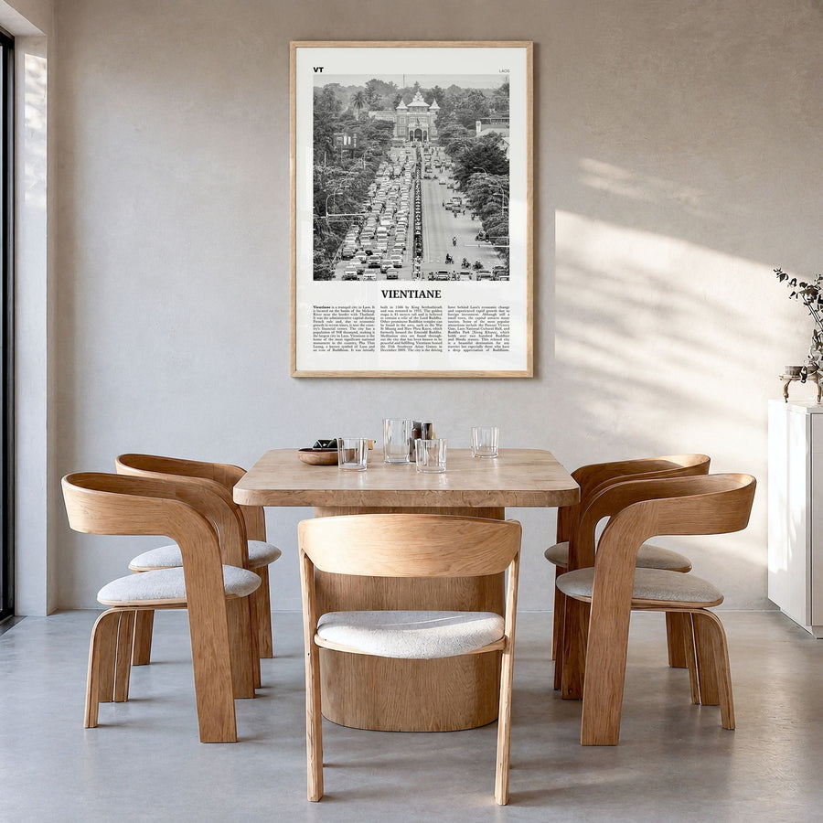 Vientiane Newspaper Poster in a natural wood frame, hanging in a dining room