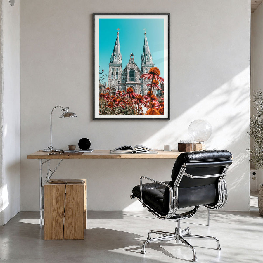 Villanova Photo Poster in a black wood frame, hanging in a bright home office, white border