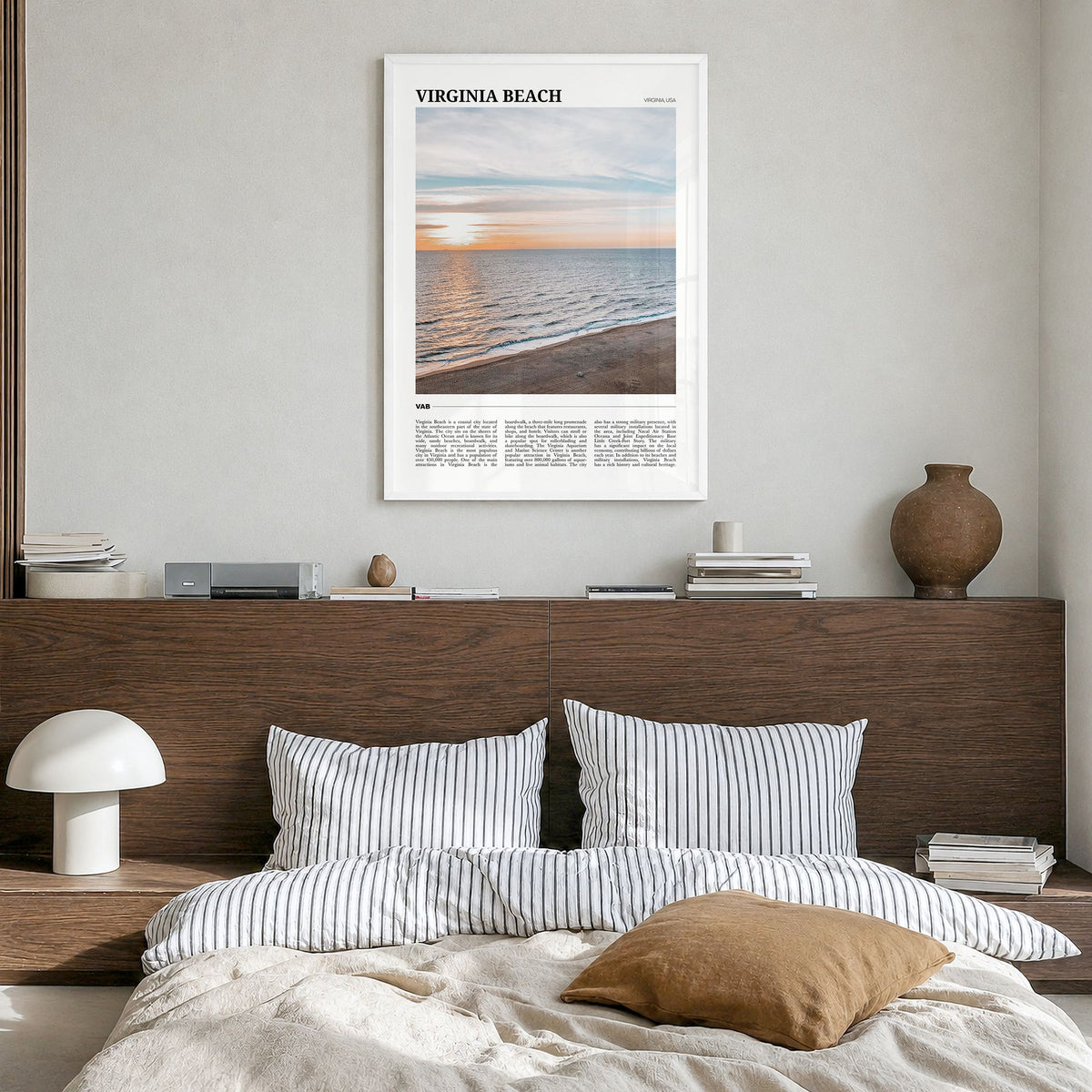 Virginia Beach Travel Poster in a white wood frame, hanging in a bedroom
