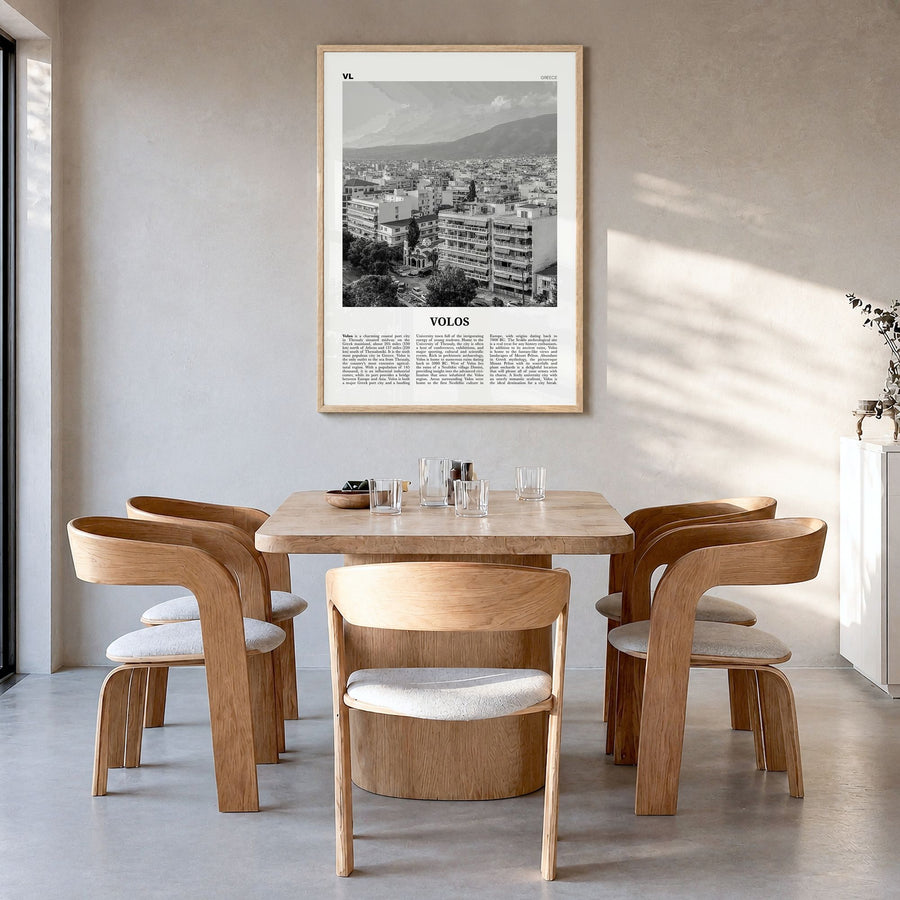 Volos Newspaper Poster in a natural wood frame, hanging in a dining room