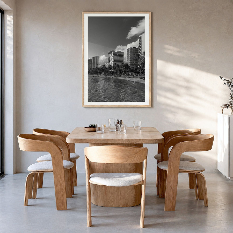 Waikiki Photo Poster in a natural wood frame, hanging in a dining room, white border