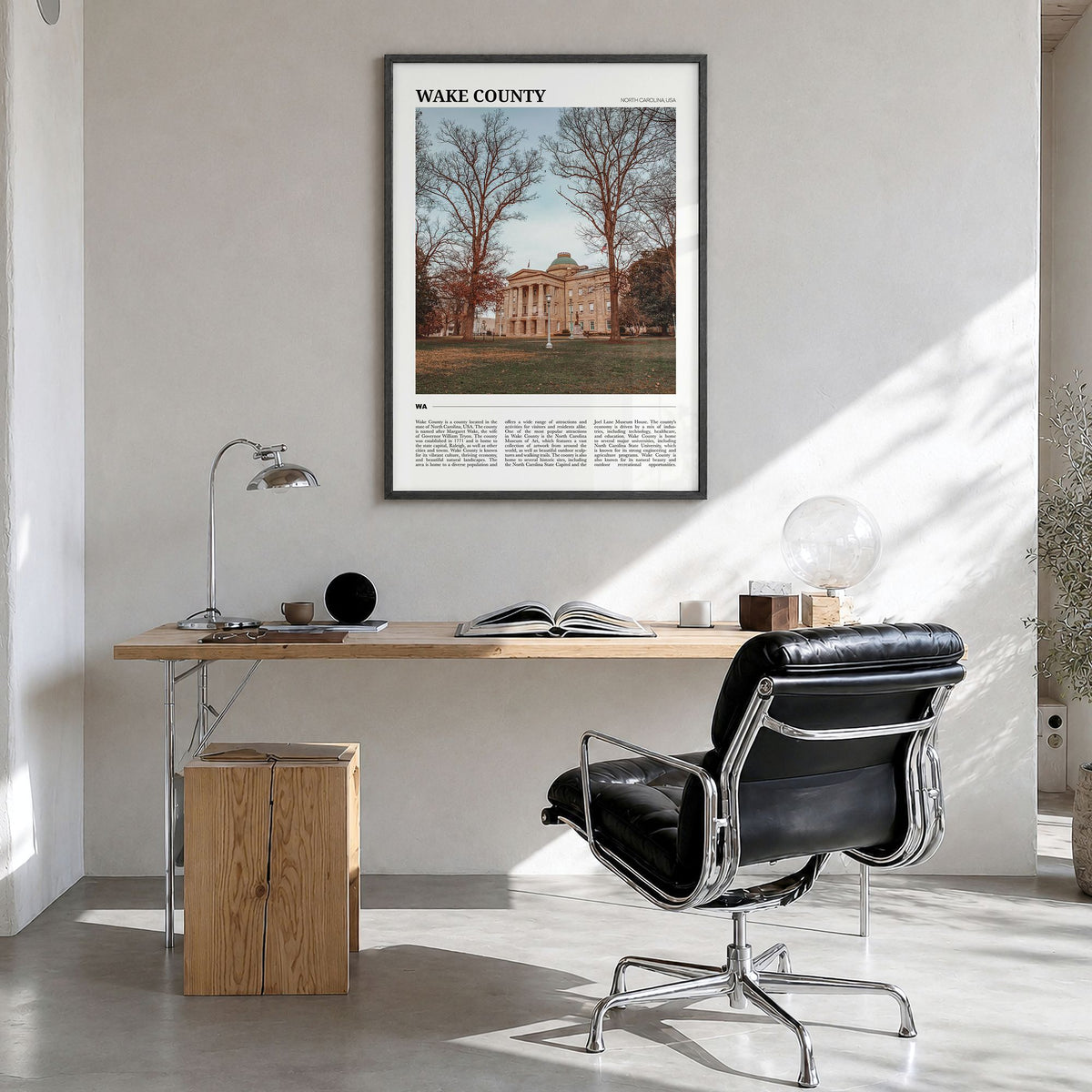 Wake County Travel Poster in a black wood frame, hanging in a bright home office