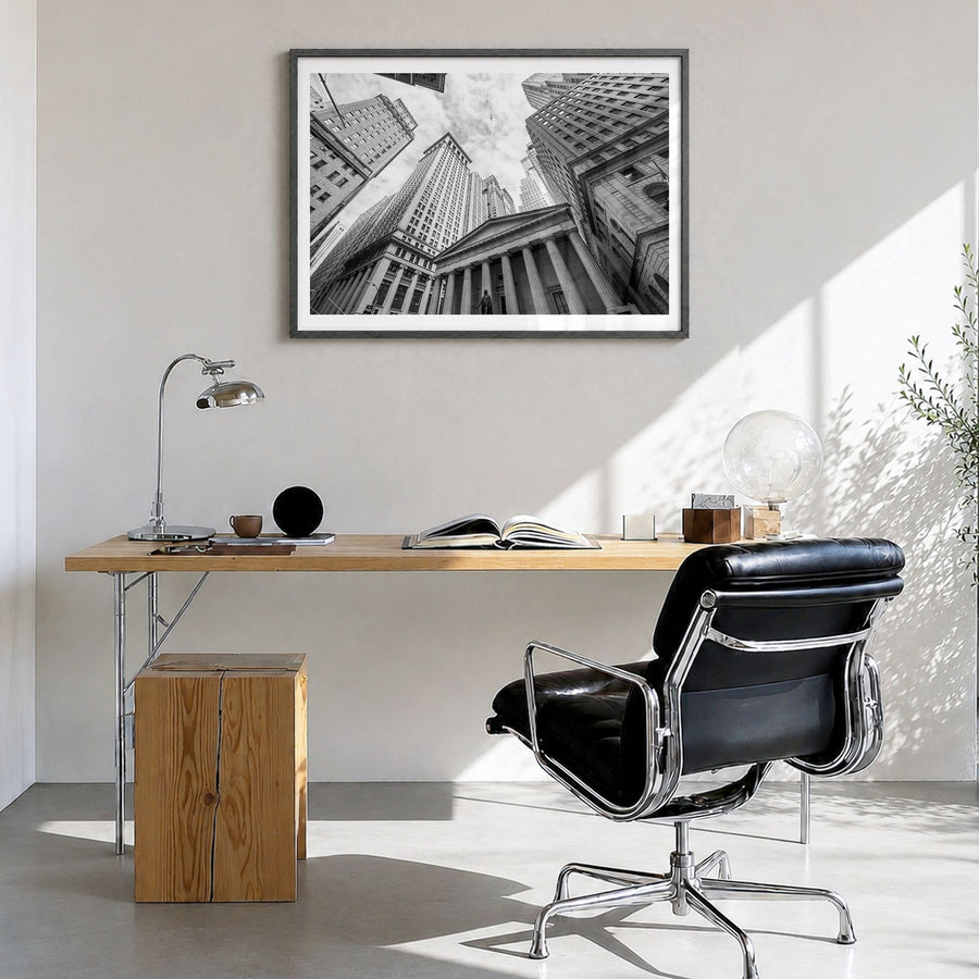 Wall Street Photo Poster in a black wood frame, hanging in a bright home office, white border