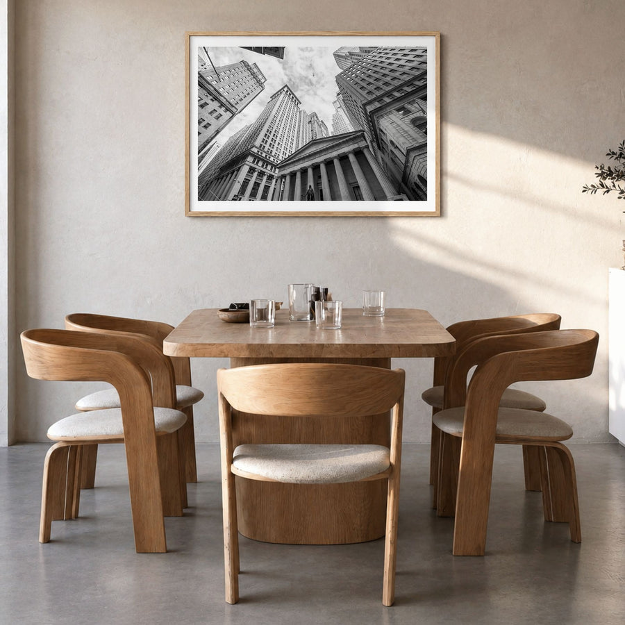 Wall Street Photo Poster in a natural wood frame, hanging in a dining room, white border