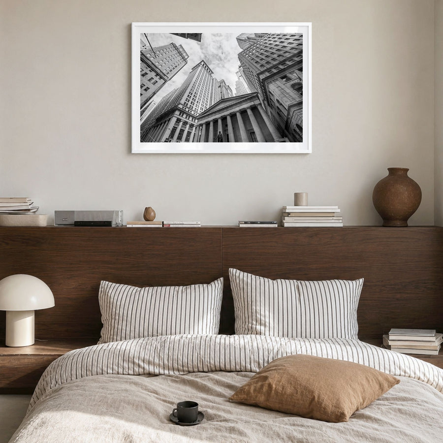 Wall Street Photo Poster in a white wood frame, hanging in a bedroom, white border