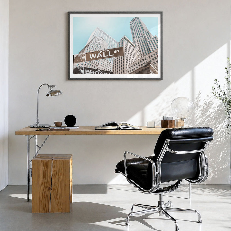 Wall Street Photo Poster in a black wood frame, hanging in a bright home office, white border