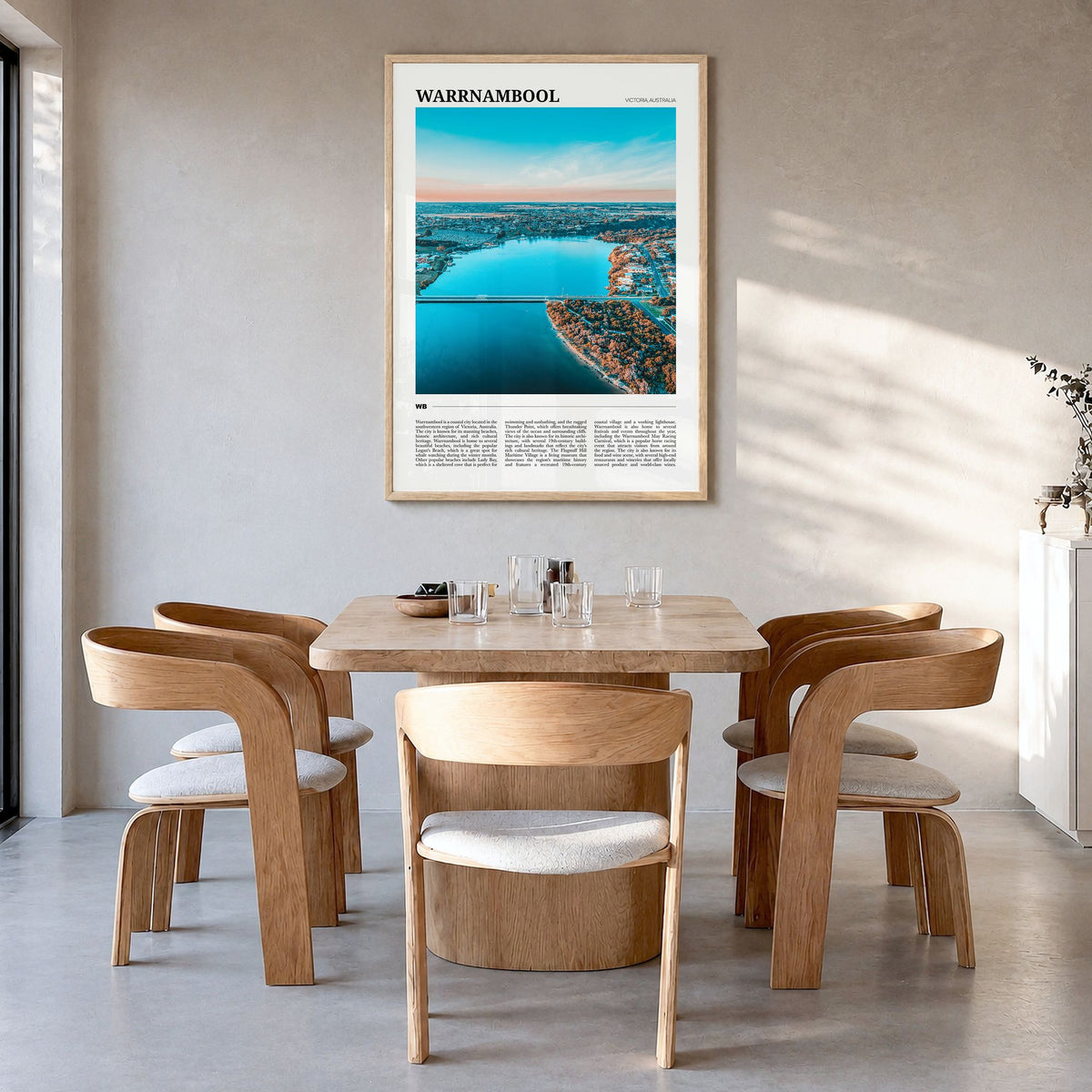 Warrnambool Travel Poster in a natural wood frame, hanging in a dining room
