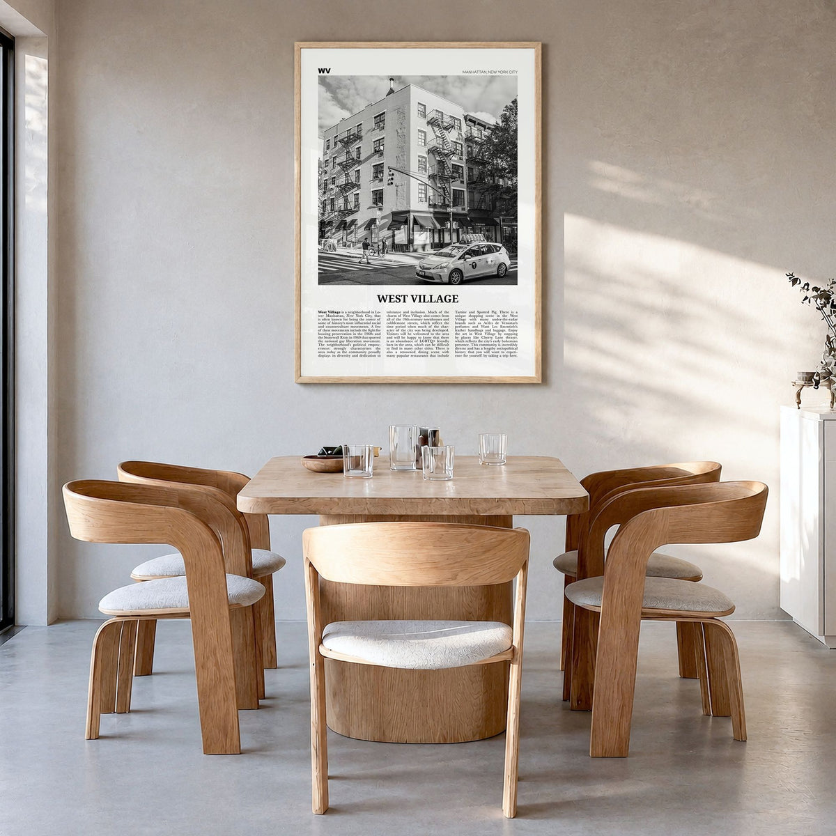 West Village Newspaper Poster in a natural wood frame, hanging in a dining room