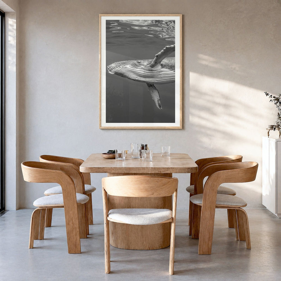 Whale Photo No 1 Poster in a natural wood frame, hanging in a dining room, white border