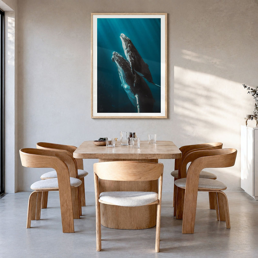 Whale Photo No 6 Poster in a natural wood frame, hanging in a dining room, white border