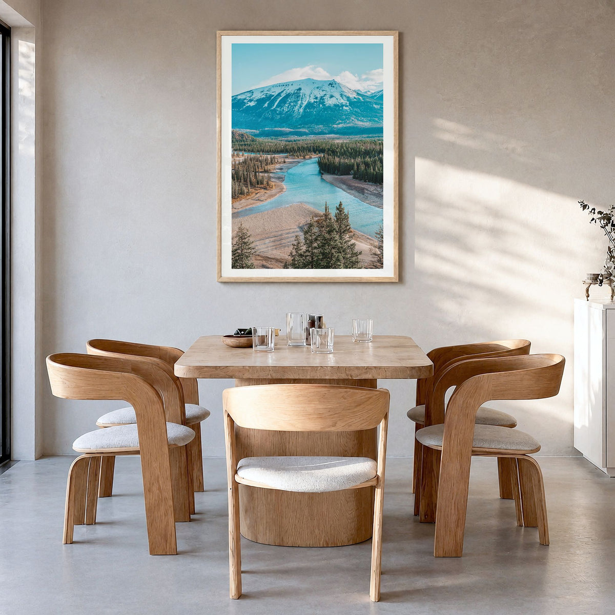 Whistler Photo Poster in a natural wood frame, hanging in a dining room, white border