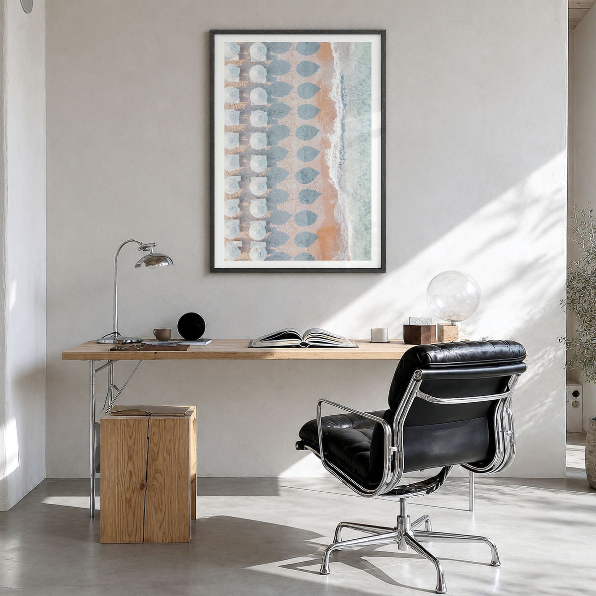 White Umbrellas Photo Poster in a black wood frame, hanging in a bright home office, white border