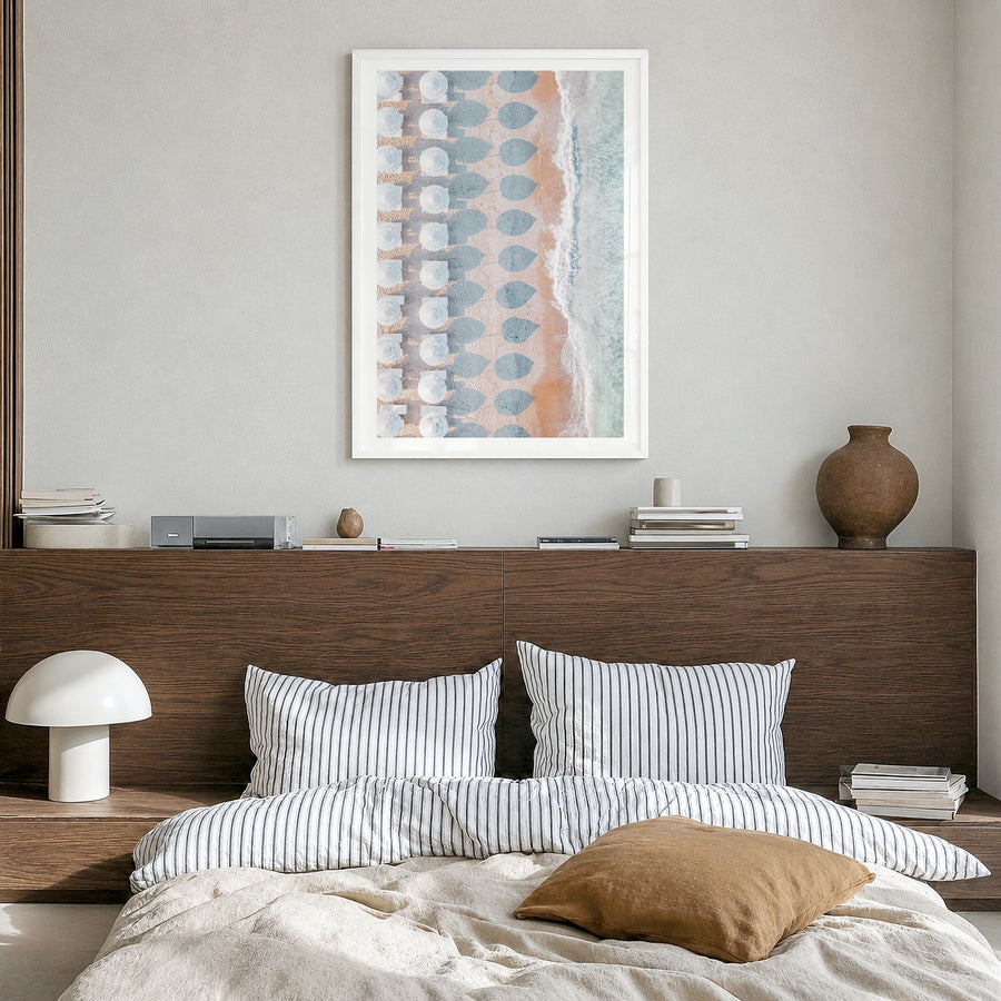 White Umbrellas Photo Poster in a white wood frame, hanging in a bedroom, white border