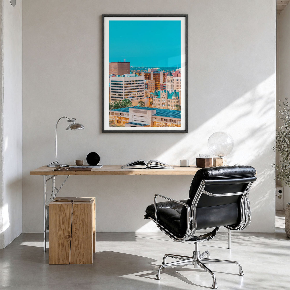 Wichita Photo Poster in a black wood frame, hanging in a bright home office, white border