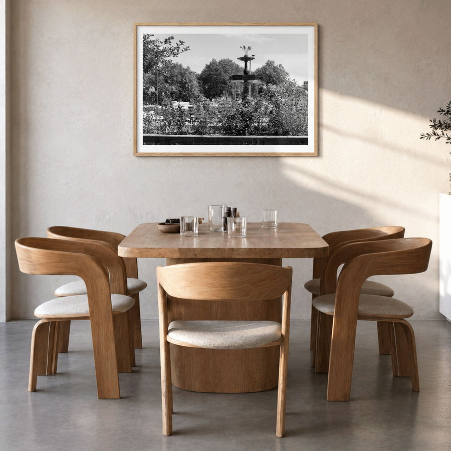Wicker Park Photo Poster in a natural wood frame, hanging in a dining room, white border