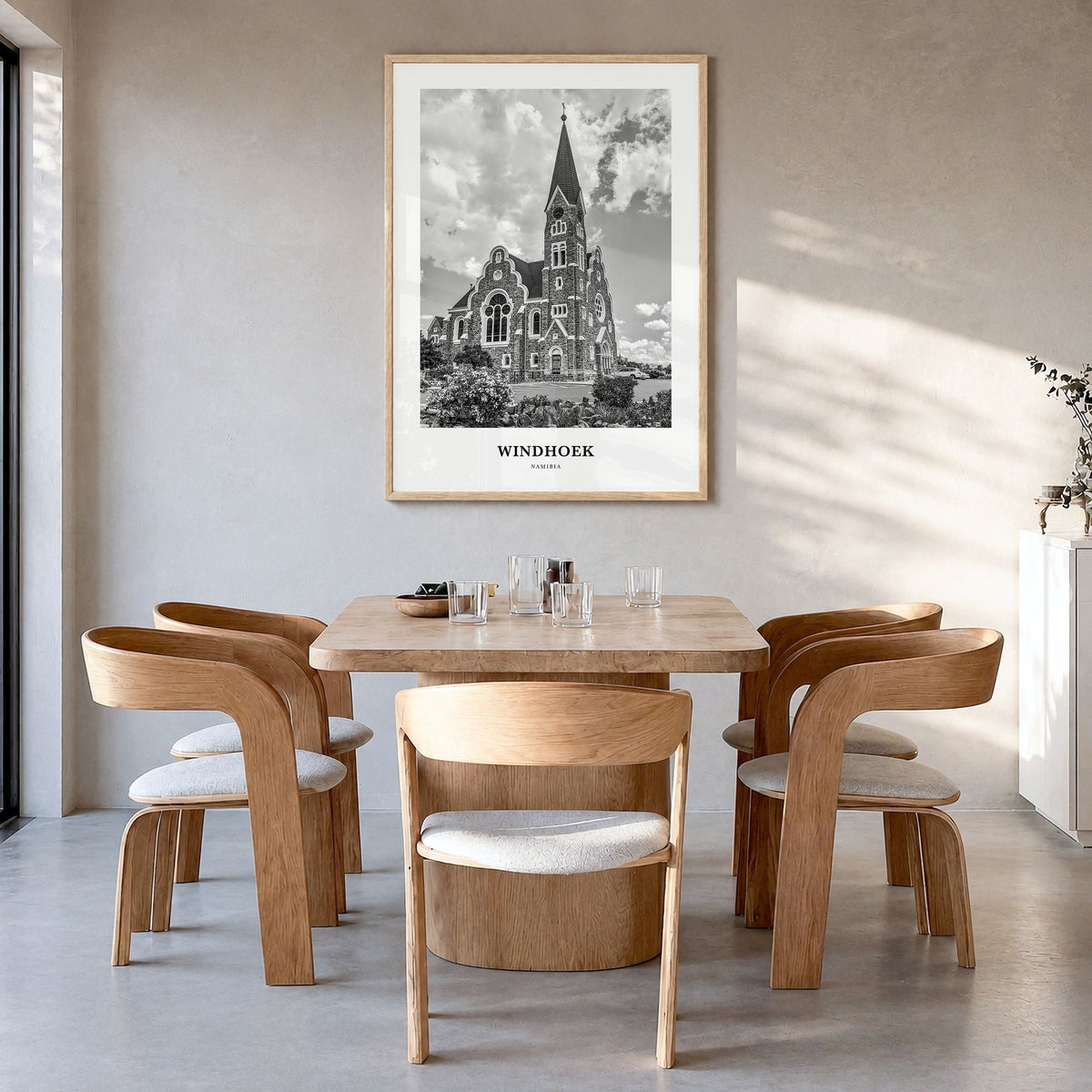 Windhoek Classic Poster in a natural wood frame, hanging in a dining room