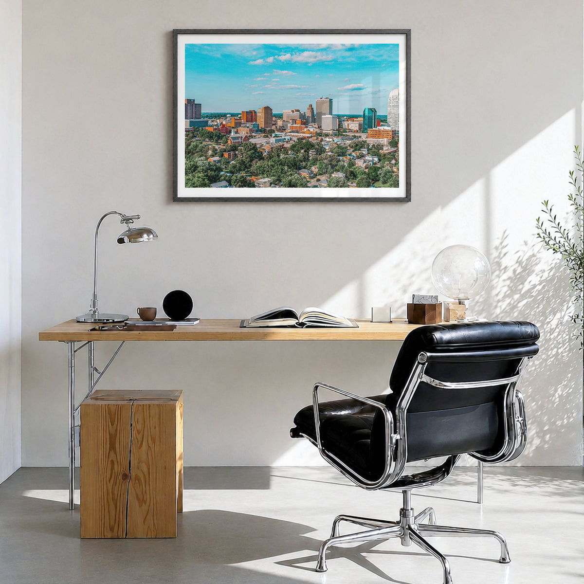 Winston-Salem Photo Poster in a black wood frame, hanging in a bright home office, white border