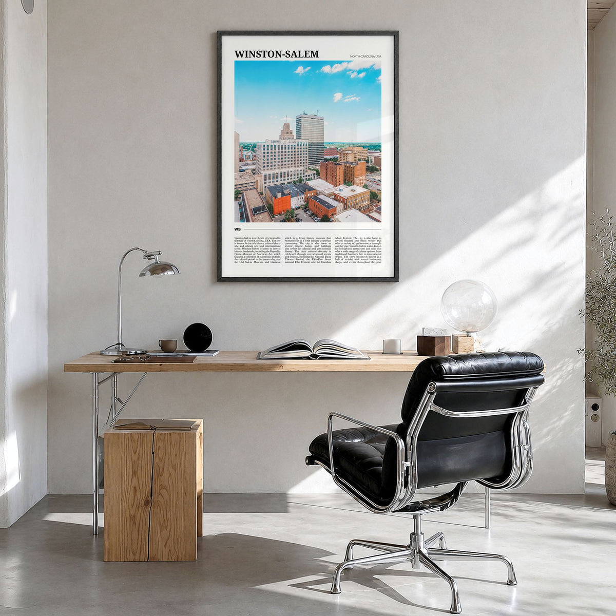 Winston-Salem Travel Poster in a black wood frame, hanging in a bright home office