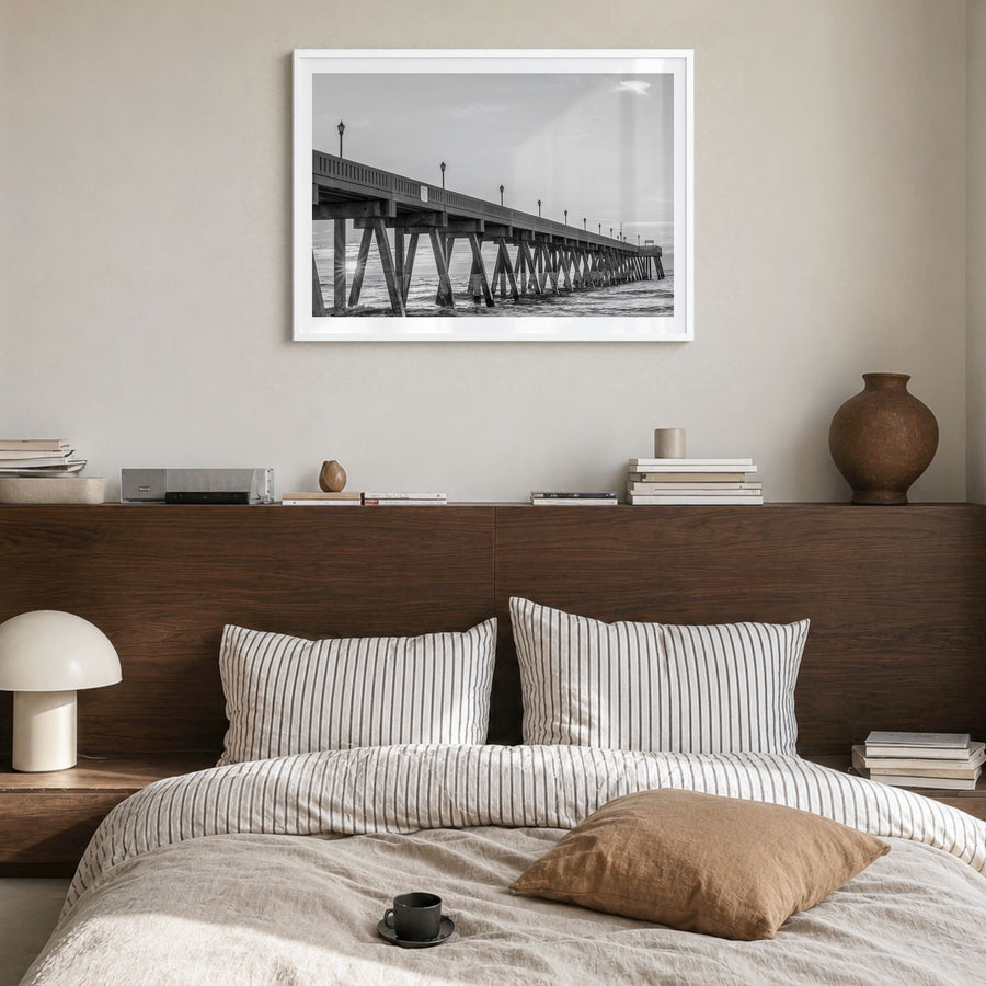 Wrightsville Beach Photo Poster in a white wood frame, hanging in a bedroom, white border