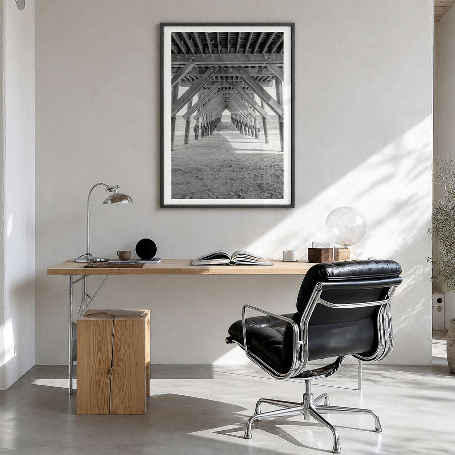 Wrightsville Beach Photo Poster in a black wood frame, hanging in a bright home office, white border