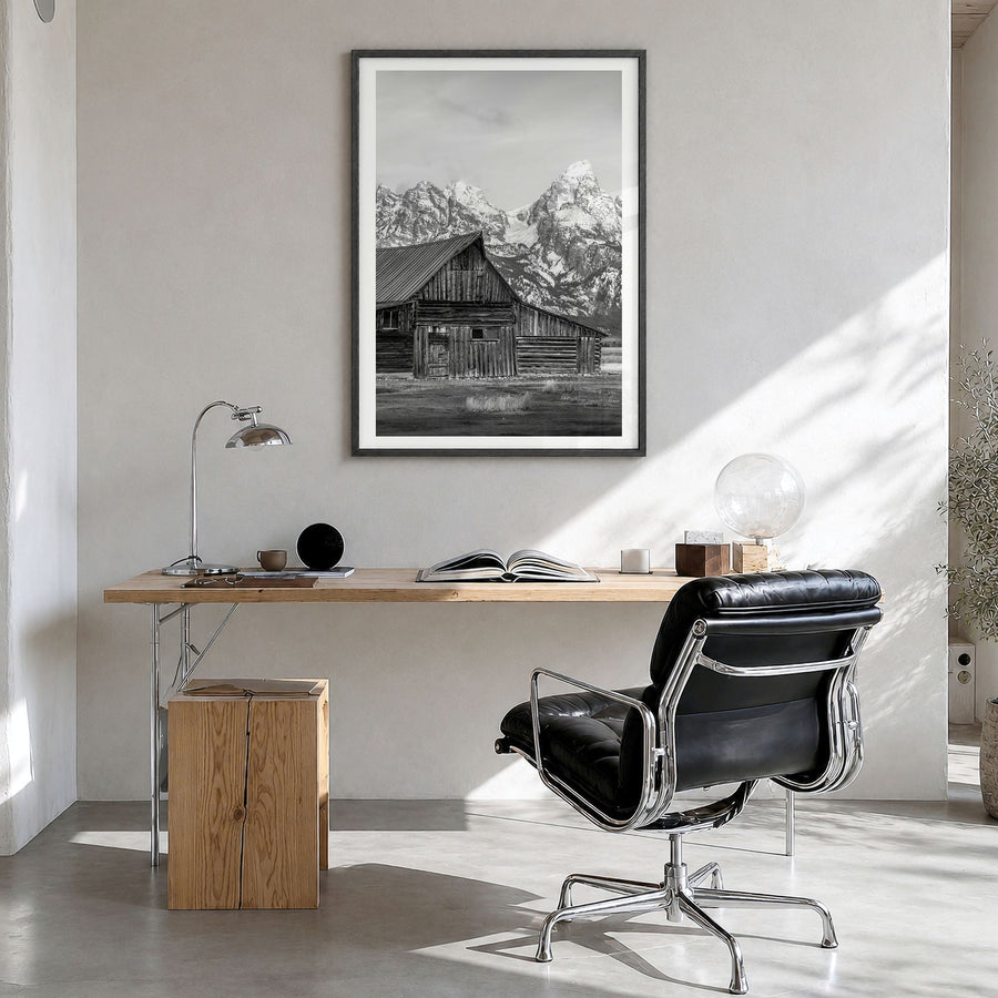 Wyoming Photo Poster in a black wood frame, hanging in a bright home office, white border