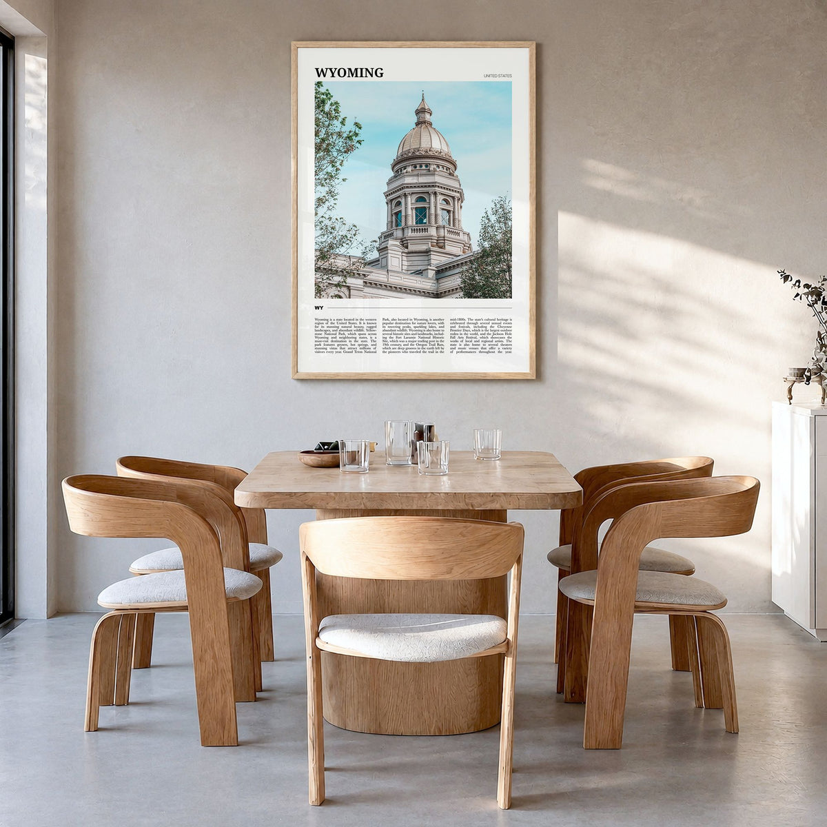 Wyoming Travel Poster in a natural wood frame, hanging in a dining room
