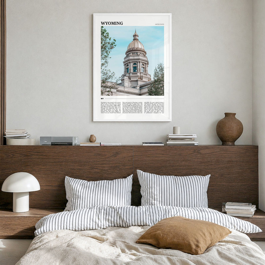 Wyoming Travel Poster in a white wood frame, hanging in a bedroom