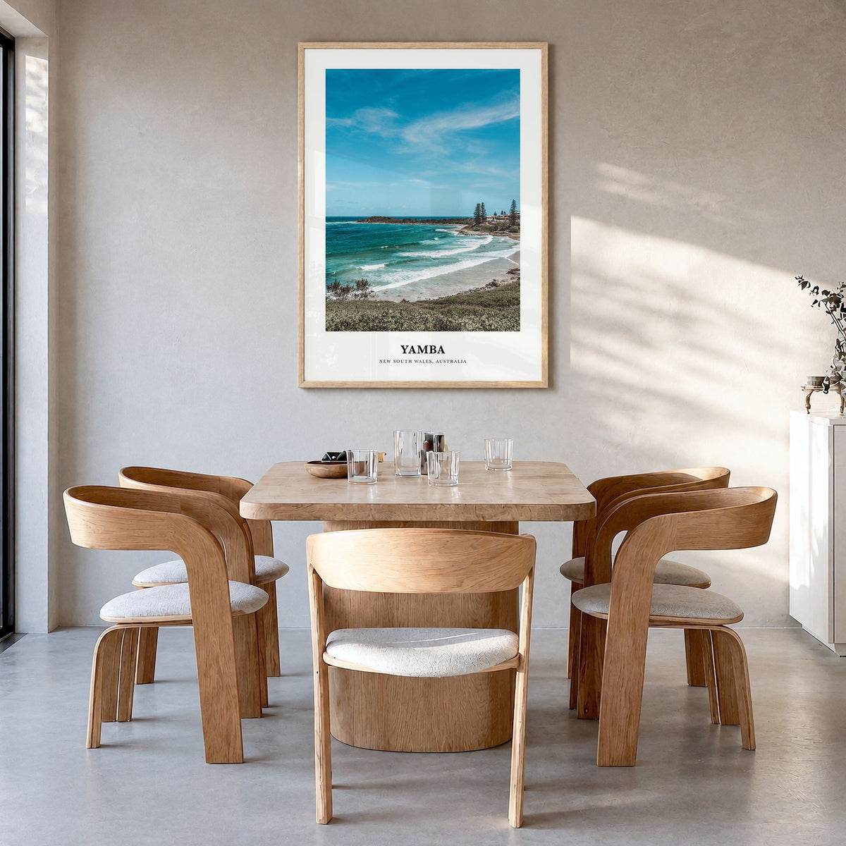 Yamba Classic Poster in a natural wood frame, hanging in a dining room