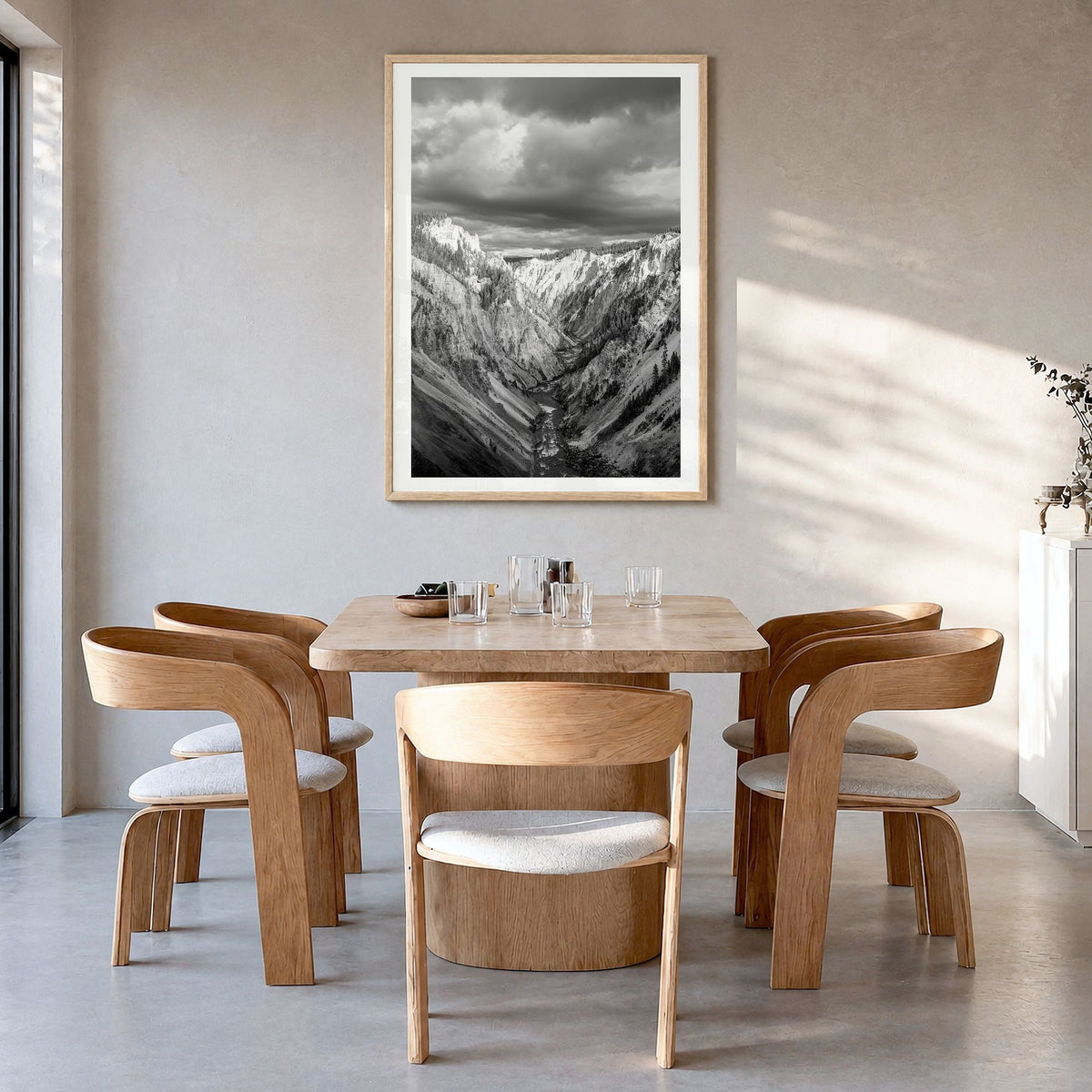 Yellowstone National Park Photo Poster in a natural wood frame, hanging in a dining room, white border