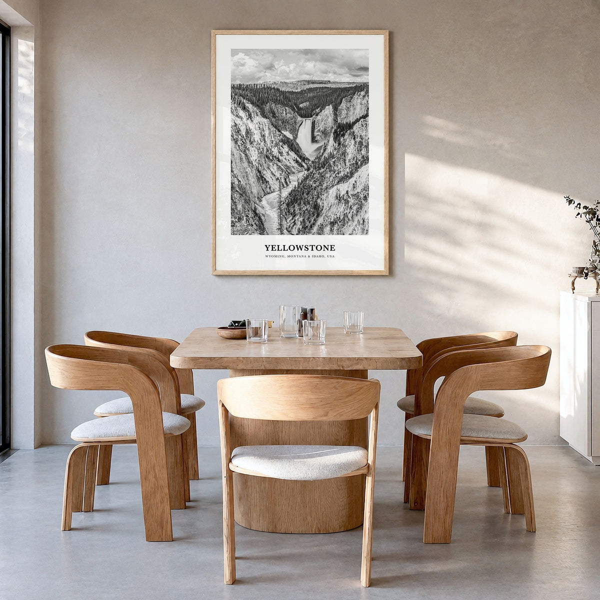 Yellowstone National Park Classic Poster in a natural wood frame, hanging in a dining room