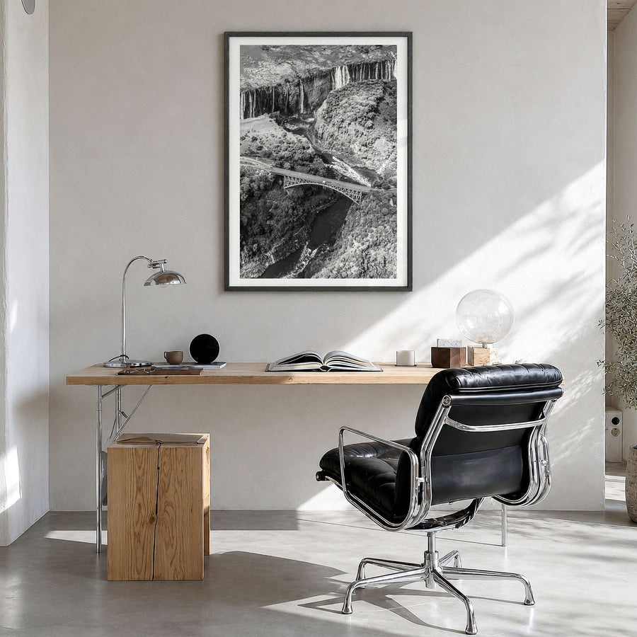 Zambia Photo Poster in a black wood frame, hanging in a bright home office, white border