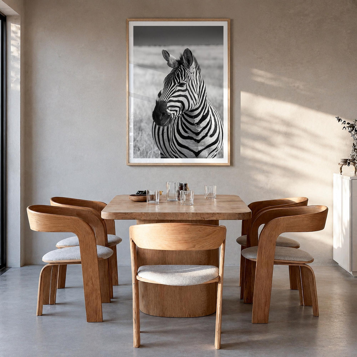 Zebra no. 1 black & white photo poster – vertical wall art in natural wood frame with white border, hanging on wall