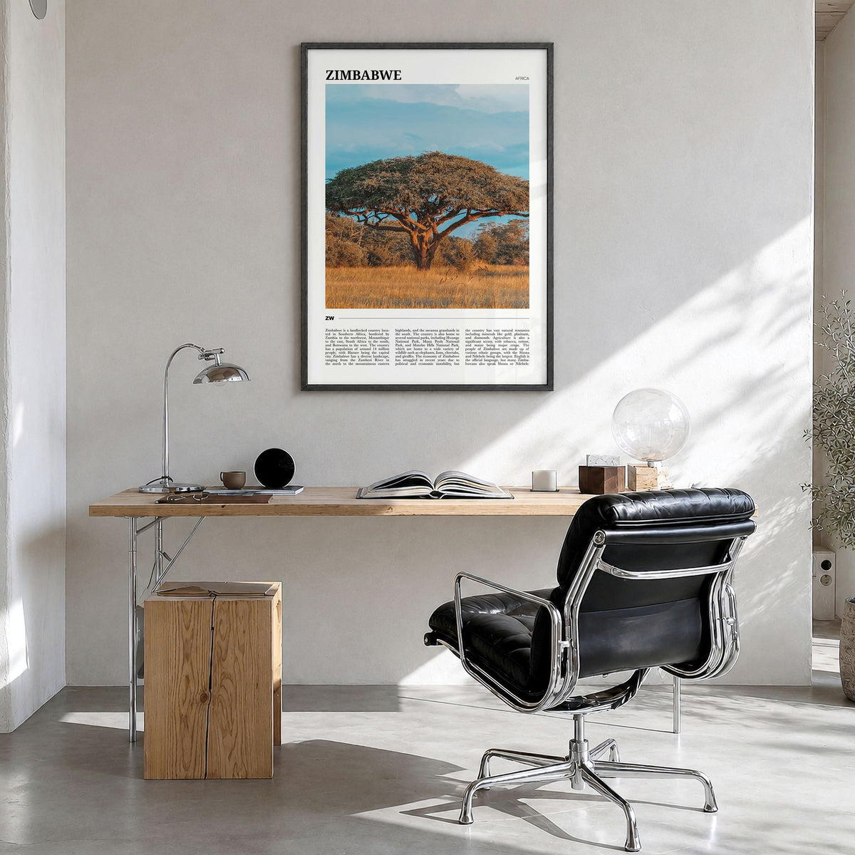 Zimbabwe Travel Poster in a black wood frame, hanging in a bright home office